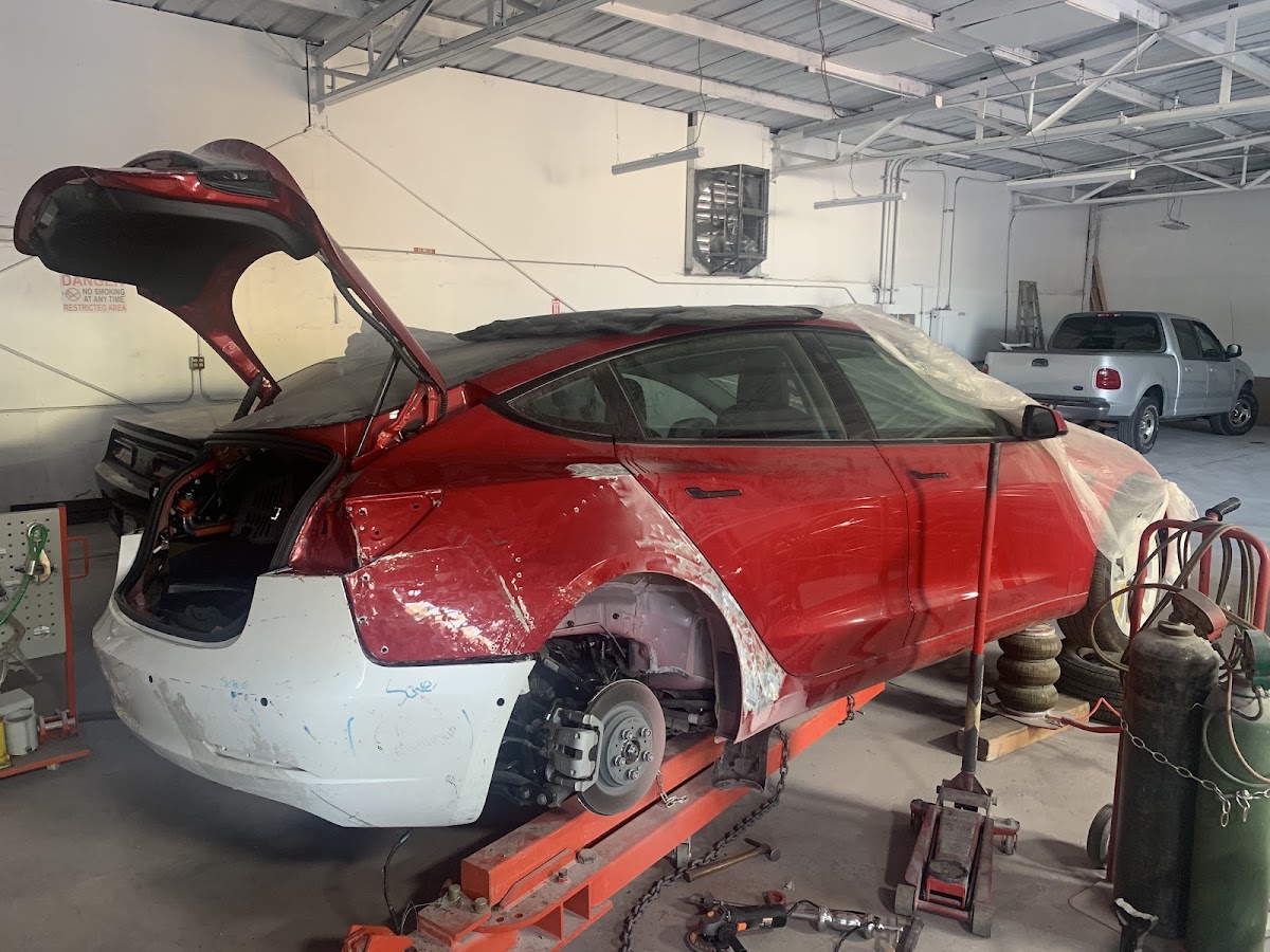 Red car on the frame rack during collision repair
